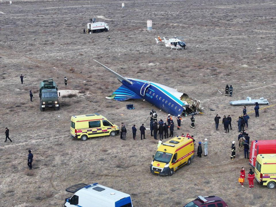 Kazakhstan emergency response teams working at the crash site to rescue survivors of the Azerbaijan Airlines plane crash